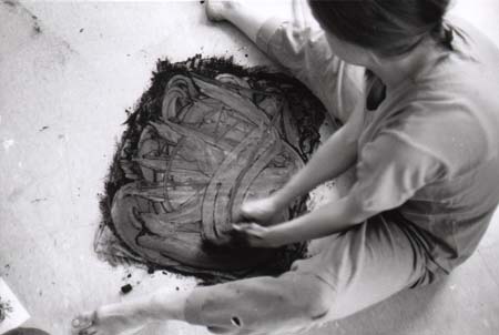 'Student sitting while drawing with both hands, first with closed eyes and later with open eyes'.